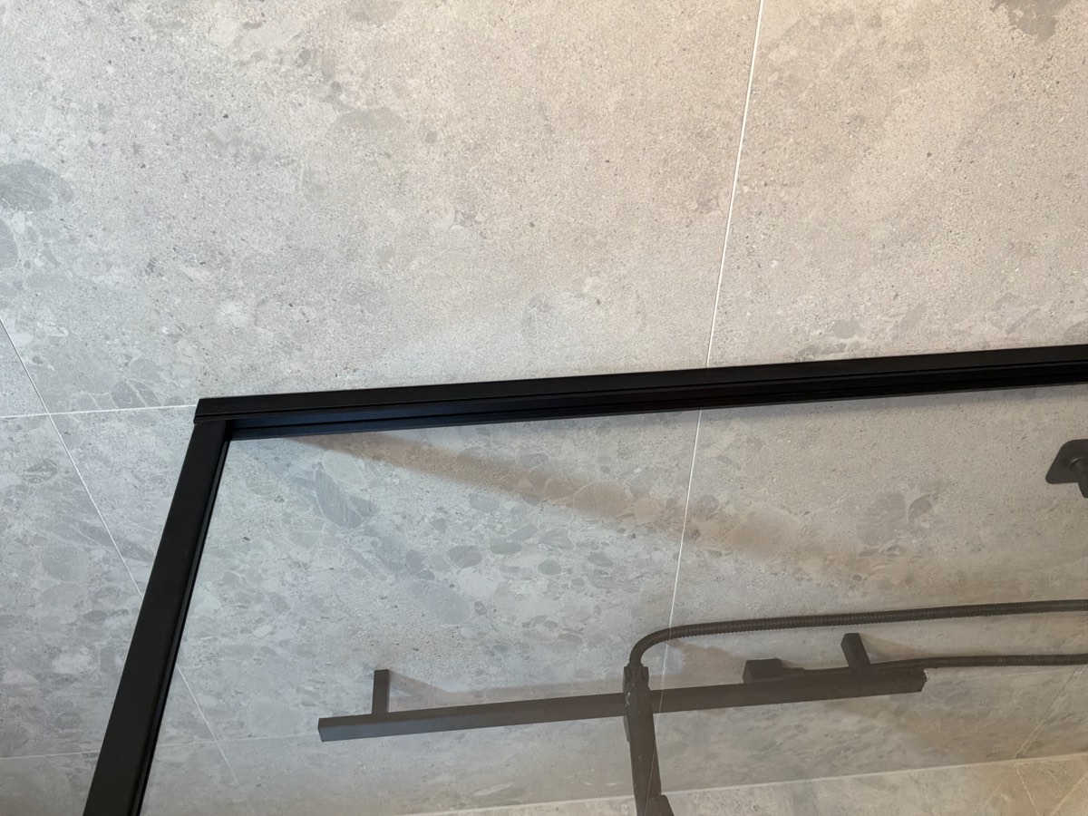 Sealing required to a shower screen, recorded during a handover inspection in Riverstone